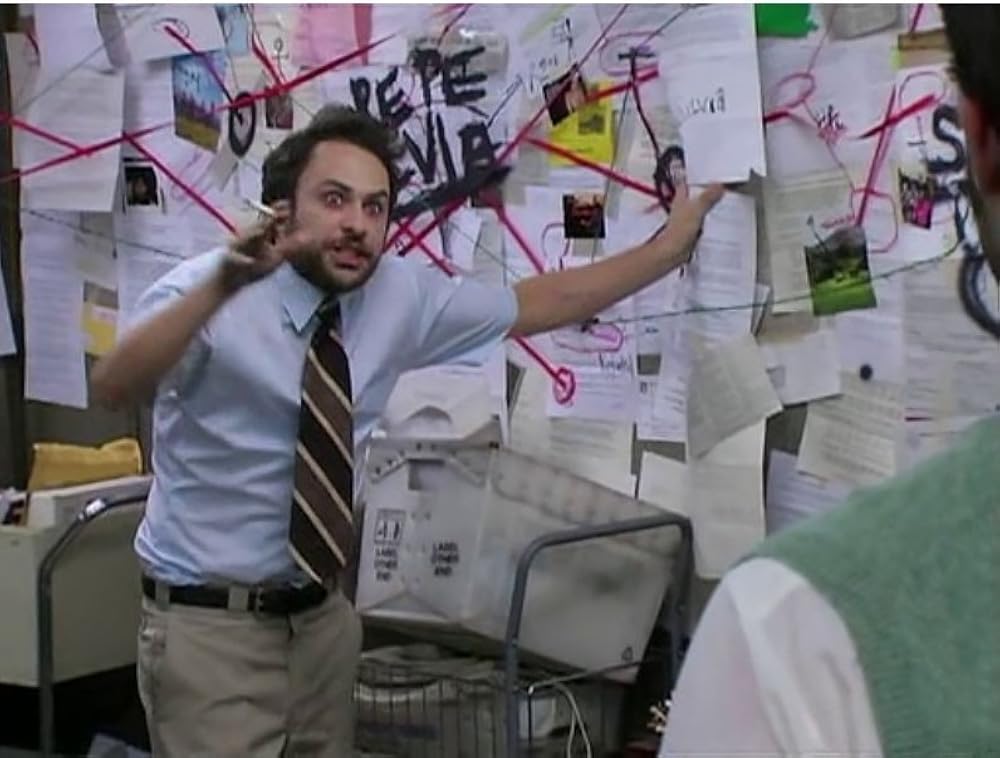 Meme image of Charlie Day from It's Always Sunny having a conspiracy theory-driven breakdown.